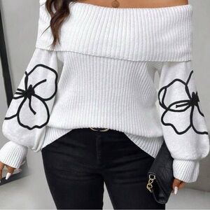Off-Shoulder White Sweater with Black Floral Design